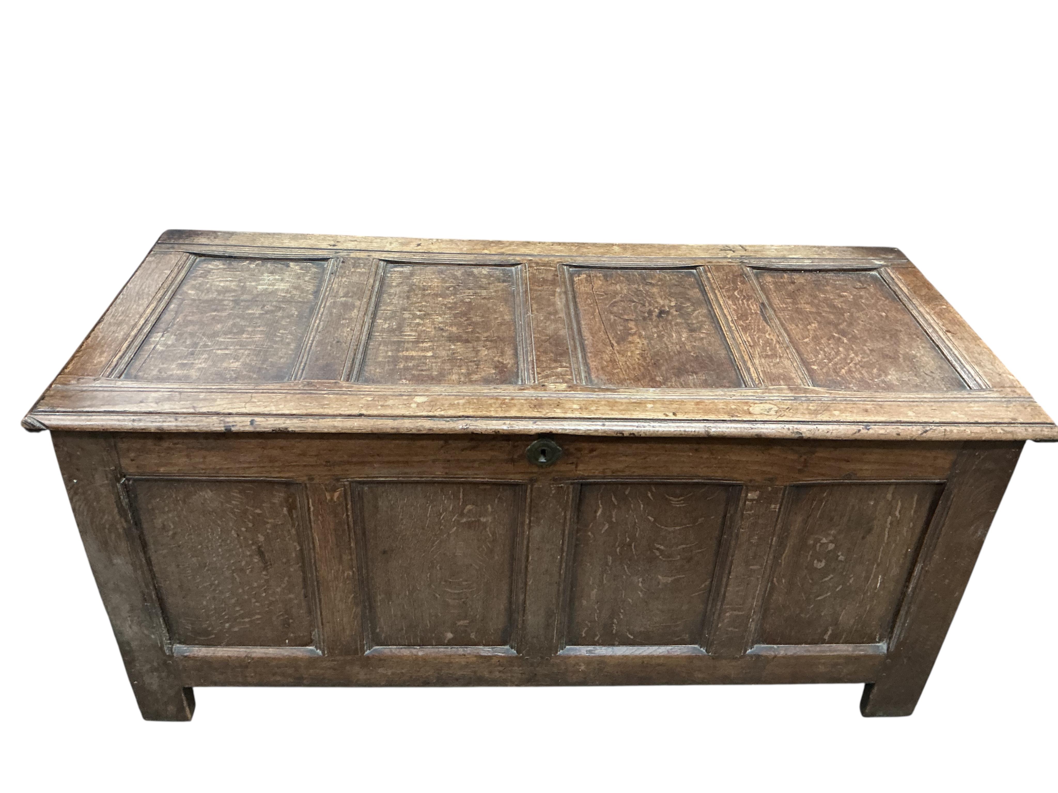 An 18th century panelled oak coffer, width 130cm, depth 55cm, height 61cm